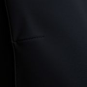 Close-up of black high waisted leggings with pockets, showcasing soft silk blend fabric, quality stitching, and textured detail.