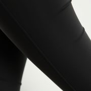 Close-up of black seamless leggings with phone pocket, highlighting soft fabric texture and premium stitching.