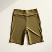 Flat lay of olive green black wide leg yoga pants seamless shorts folded on a neutral surface.