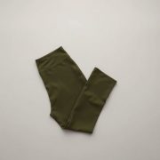 Flare black yoga pants high waist in olive green, neatly folded on a neutral surface, top-down view.