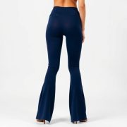 A model wearing flare leggings Australia in navy blue, showcasing the flared fit from behind on white background.