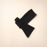 Flat lay of charcoal flare leggings black scrunch bum leggings neatly folded on a neutral surface.