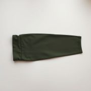 High waisted yoga pants in olive green, petite size, neatly folded on a neutral surface, top-down view.