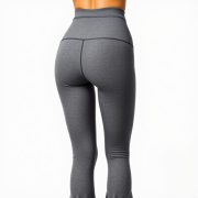 Back view of a model wearing high waist seamless flare leggings in Heather Grey, studio shot on white background.