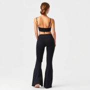 Back view of a model wearing yoga pants and yoga flare pants in Black, showcasing fit on pure white studio background.