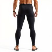 A model wearing high-waisted black yoga pants men in Charcoal, studio shot on white background.