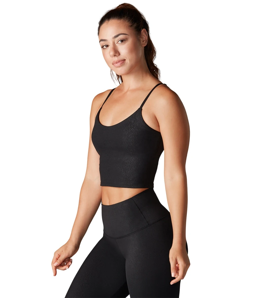 pink boob tube drying flat on towel next to yoga blocks