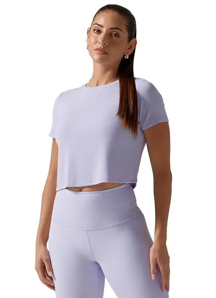 yellow sports shirt styled with black leggings and denim jacket for a streetwear look